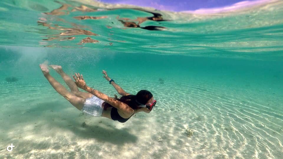 Clear view underneath sea level using Telesin Dome on GoPro Hero 5 Action Camera at Maniuaya Island. 