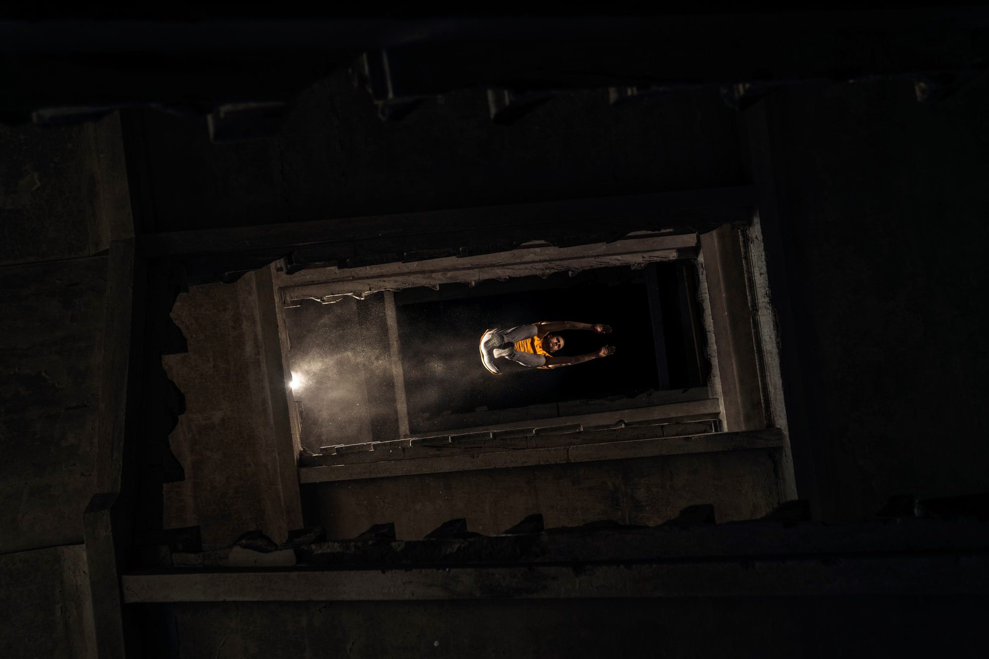 A precise jump of a Parkour athlete in an abandoned building;