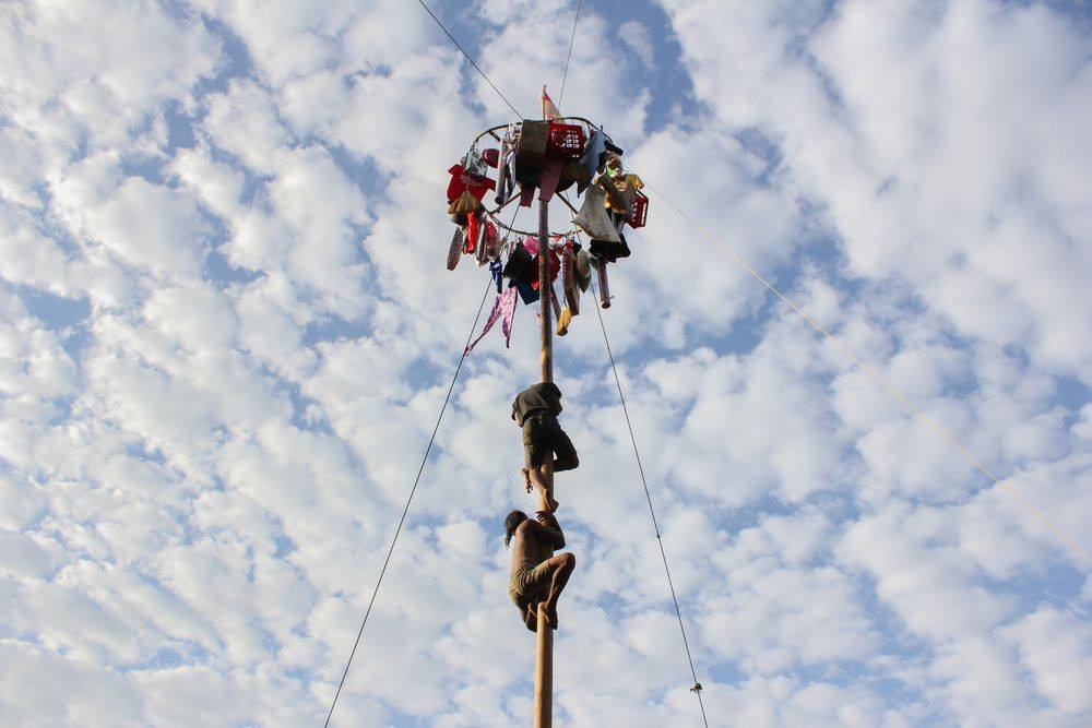 Panjat Pinang is a traditional game observed in Indonesian Independence Day. The challenge is to climb up a greasy pole to reach for the prizes hung up top the of the tree. This challenging game teaches the value of teamwork. We celebrate alongside our friends in Indonesia on this festive occasion!